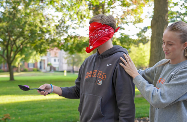 Management student guides blindfolded classmate after they've found a hidden object.