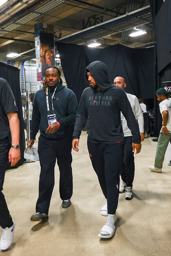 Martone walking with New York Knicks Superstar Jalen Brunson