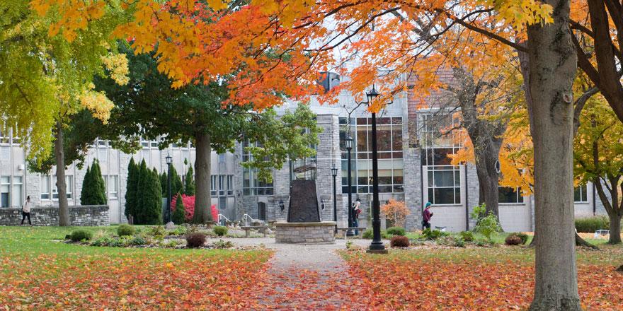 Gilmor Science Hall in the background with fall foliage in the foreground