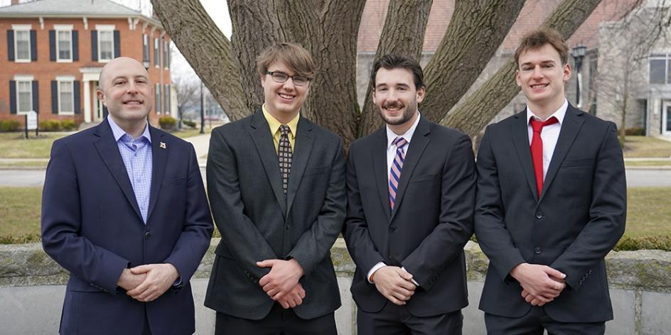The winning team in the 2022 Ethics Case Competition: David Haines, Ryan Waskiewicz and Spencer Tredwell and their professor, Scott Miller