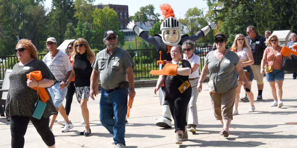 Families & Benefactors make their way to the football game after a tailgate lunch.