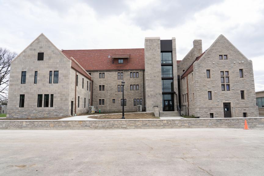 France Residence Hall pictured on a cloudy day, pavement in front of the picture