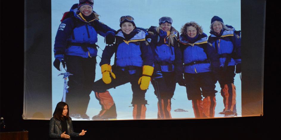 Alison Levine talks in front of projected picture of her team on Mount Everest