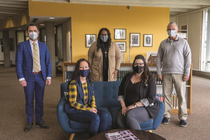 Group gathers for photo, wearing masks, in Beeghly Library lobby