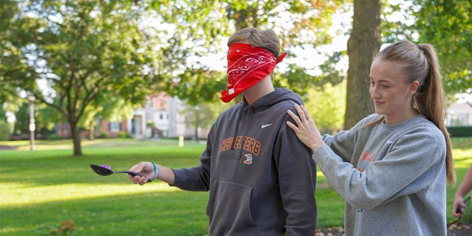 Management student guides blindfolded classmate after they've found a hidden object.