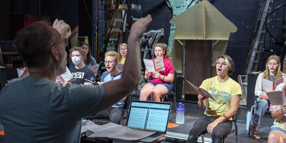 Dr. Greg Ramsdell conducts vocal rehearsal at the music & theatre summer camp.