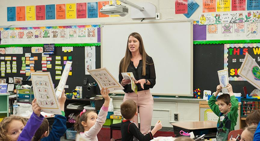 Student teaching in front of an elementary class