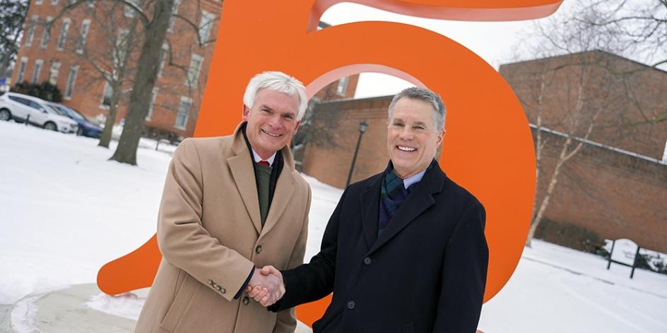 Congressman Bob Latta and President Rob Huntington stop for a photo at the Heidelberg H sculpture.