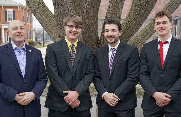The winning team in the 2022 Ethics Case Competition: David Haines, Ryan Waskiewicz and Spencer Tredwell and their professor, Scott Miller