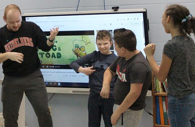 Senior theatre Gavin Buurma rehearses with School of Opportunity children.