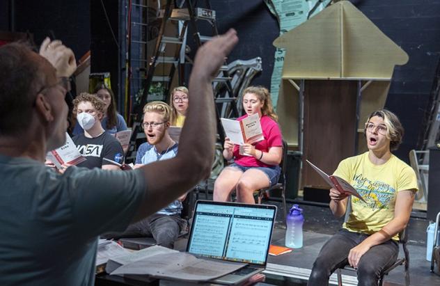 Dr. Greg Ramsdell conducts vocal rehearsal at the music & theatre summer camp.