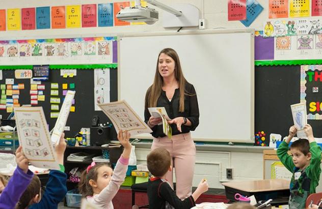 Student teaching in front of an elementary class
