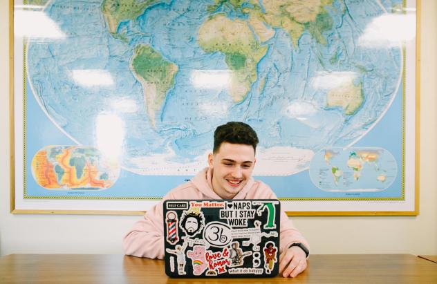 student in front of map