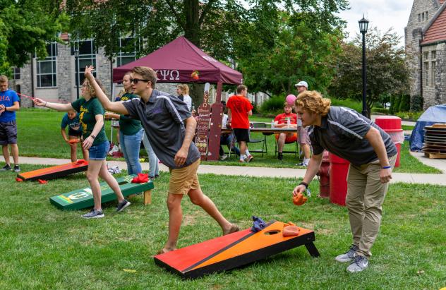 students playing corn hole