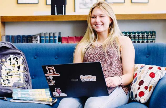 student works on laptop