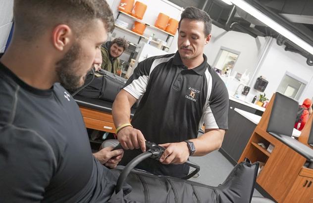 Two students work in a physical therapy setting