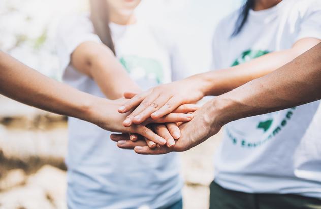 Group of people putting their hands together