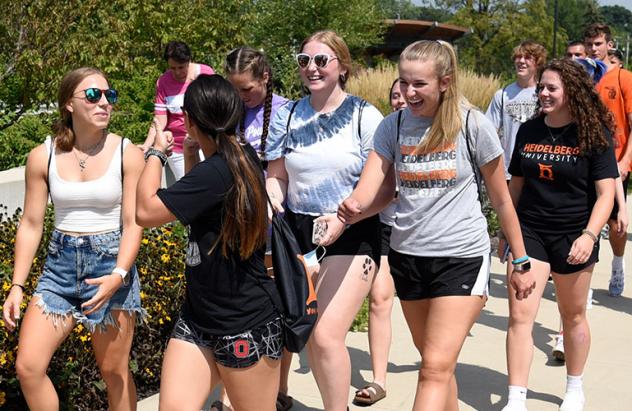 Students walk in front of amiptheater on their way to event downtown
