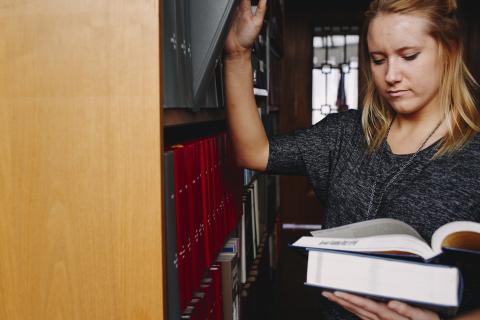 student in library