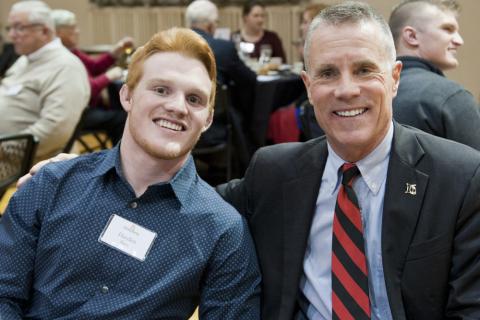 President Huntington pictured with a student in 2019