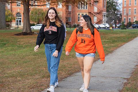 Two students walking on campus